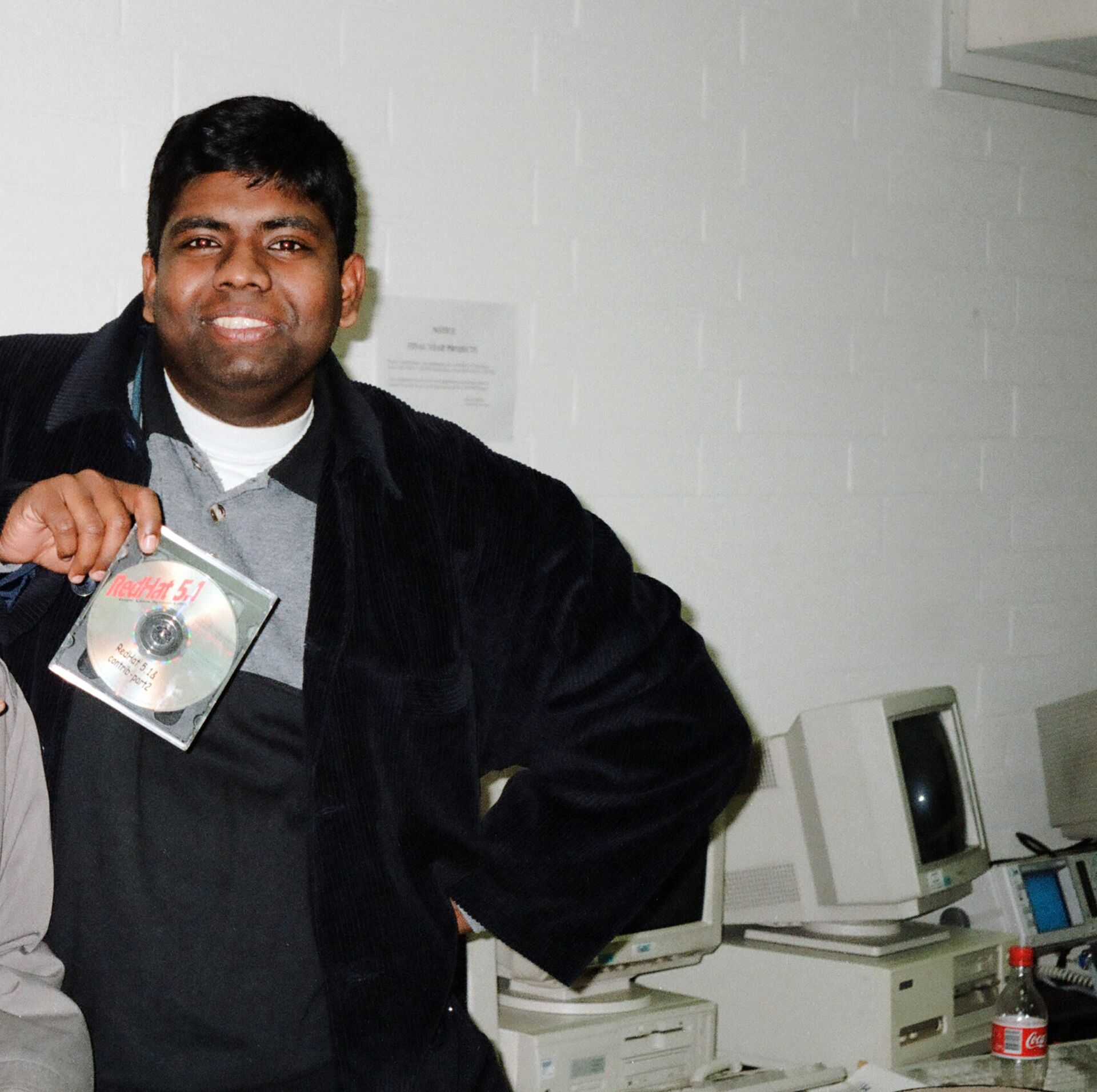 Me holding a Red Hat Linux 5.1 CD, circa 1998