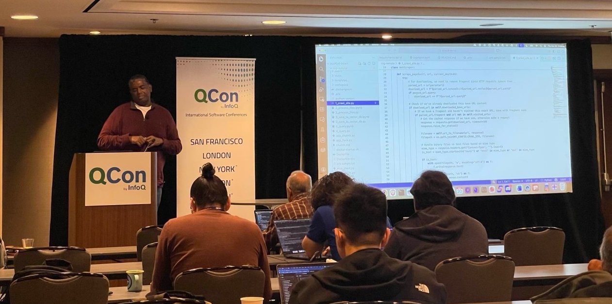 Sujee presenting to an audience at QCon